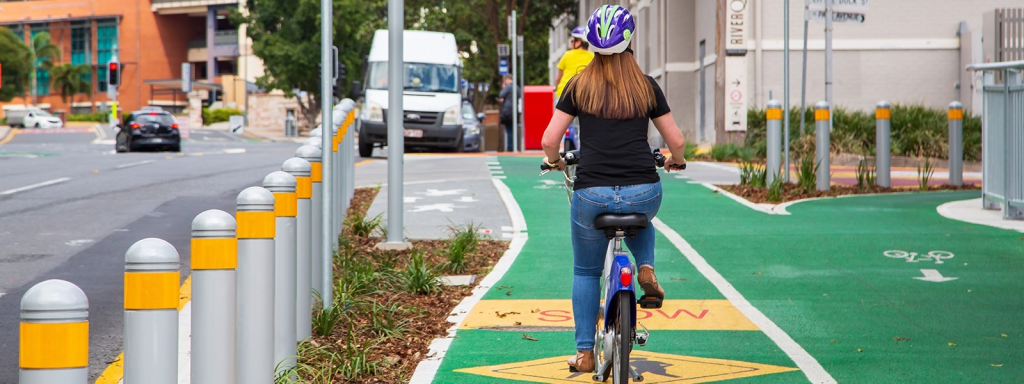 A woman cycling along a segregated path in Brisbane